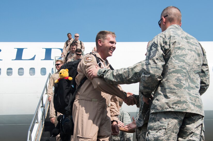 Joint Base Charleston leadership greets Lt. Col. Todd Groomes, 17th Airlift Squadron commander, during the 17th Airlift Squadron’s redeployment Sept. 3, 2013,  at Joint Base Charleston - Air Base, S.C. More than 100 Airmen from the 17th AS returned home from a  deployment to Southwest Asia. Flying the C-17 Globemaster III, crews flew and supported roughly 790 sorties, logged more than 1,860 combat flying hours and airlifted more than 19.5 million pounds of cargo. (U.S. Air Force photo/Tech. Sgt. Rasheen Douglas)