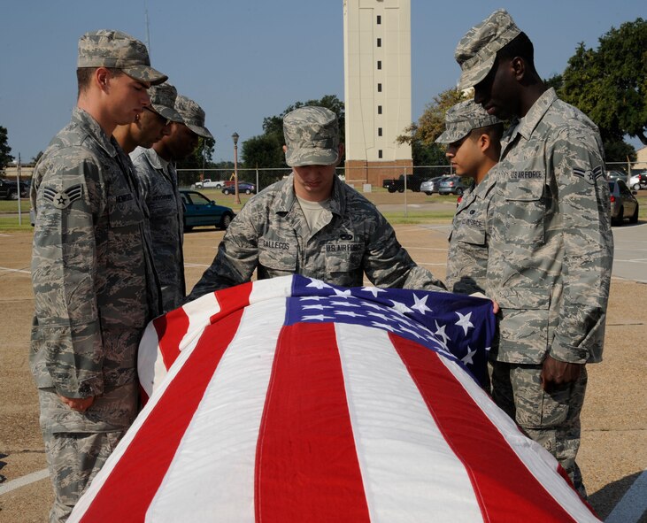 Airmen from Barksdale Honor Guard Bravo flight prepare to lift a casket during training on Barksdale Air Force Base, La., Sept. 4, 2013. These Airmen train constantly to perfect their role as Honor Guardsmen, practicing drill and ceremony during their two-week shift. (U.S. Air Force photo/Airman 1st Class Andrew Moua)