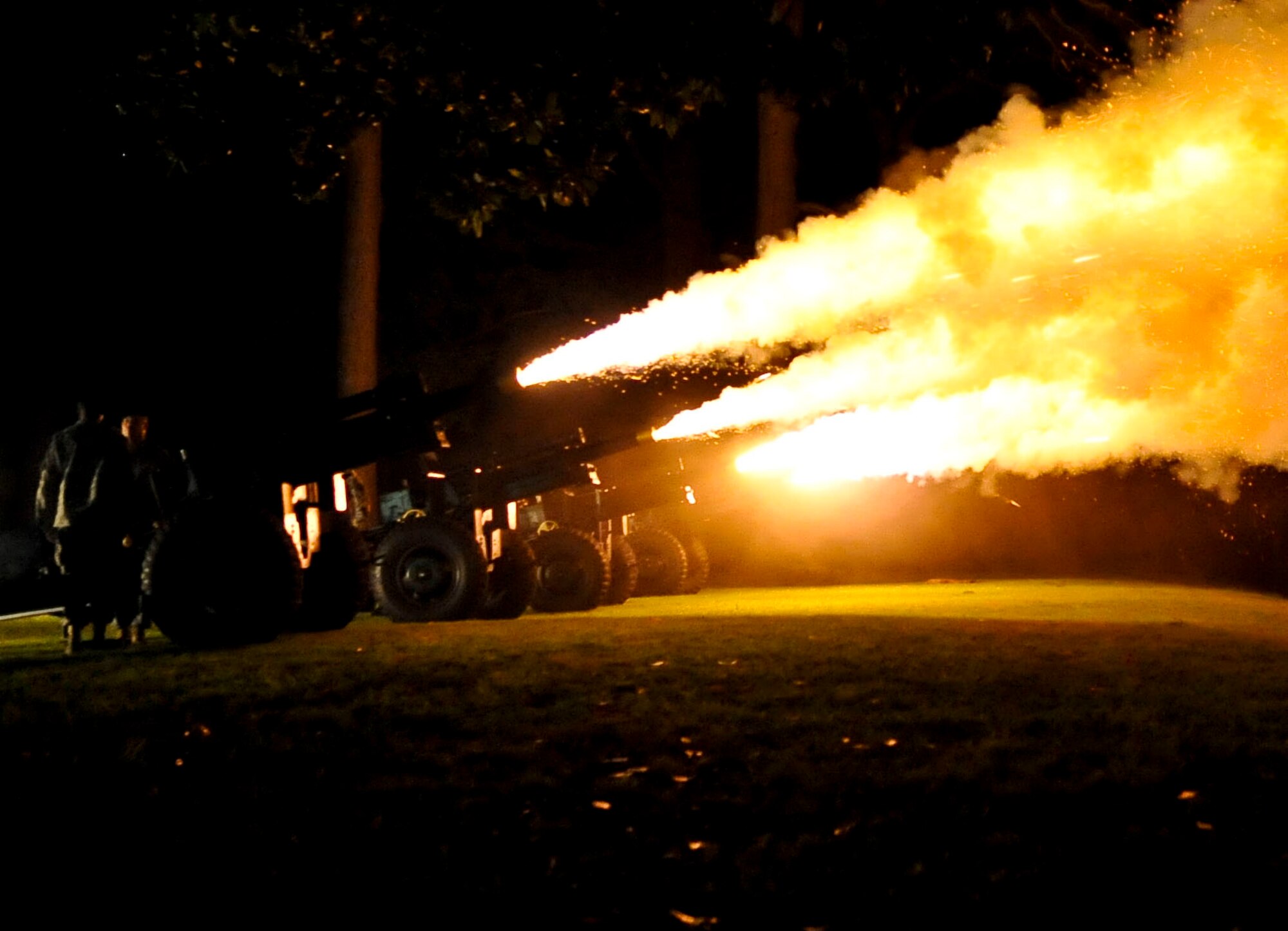 The U.S. Army Training and Doctrine Command Salute Battery fires four simultaneous cannon rounds during the TRADOC Band’s “Music Under the Stars” season finale concert in Magnolia Park at Fort Eustis, Va., Aug. 29, 2013. During the concert, fans were treated to a variety of music, including a special performance by the Williamsburg Fifes and Drums. (U.S. Air Force photo by Staff Sgt. Wesley Farnsworth/Released)
