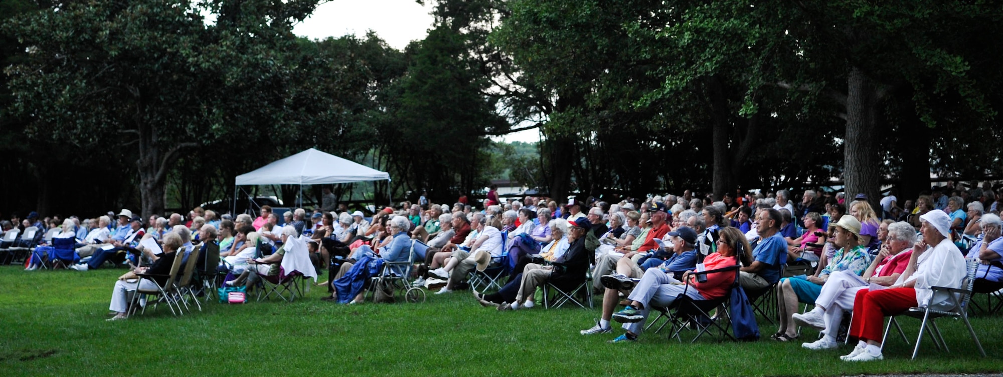 More than 600 people gather in Magnolia Park at Fort Eustis, Va., to enjoy the final concert of the 2013 “Music Under the Stars” series, hosted by the U.S. Army Training and Doctrine Command Band, Aug. 29. 2013. The TRADOC Band played a wide variety of music, including a special presentation featuring cannon firings by the TRADOC Salute Battery. (U.S. Air Force photo by Staff Sgt. Wesley Farnsworth/Released)