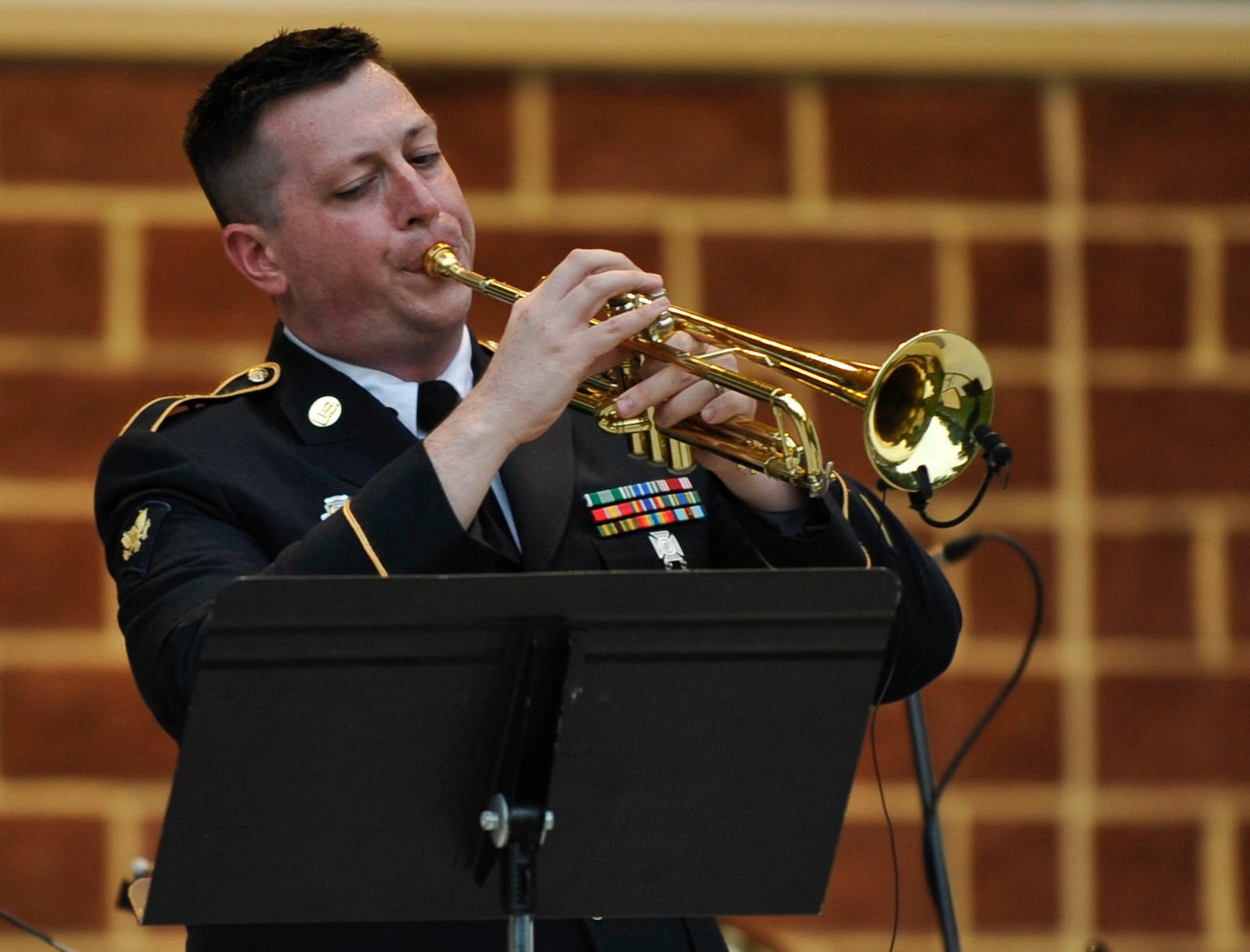 U.S. Army Spc. Chris Arnold, U.S. Army Training and Doctrine Command Band trumpet player, performs a solo during the band’s performance of “The Man with the Horn” at the “Music Under the Stars” season finale concert in Magnolia Park at Fort Eustis, Va., Aug. 29, 2013. During the concert, fans were treated to a variety of music, including a special performance by the Williamsburg Fifes and Drums. (U.S. Air Force photo by Staff Sgt. Wesley Farnsworth/Released)