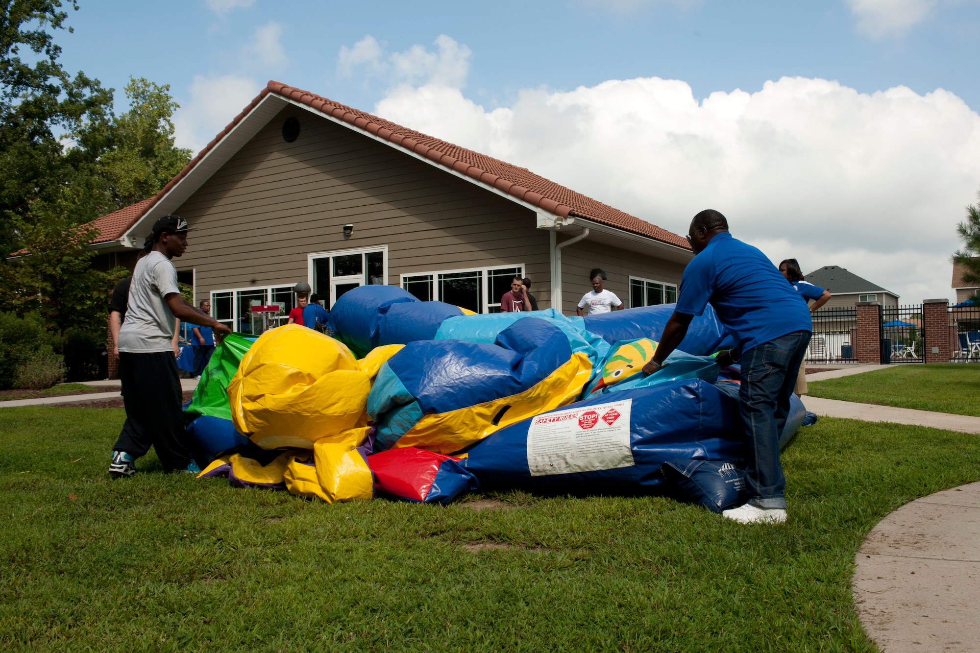 Volunteers set-up a bounce house during the Langley Air Force Base Back to School Celebration in Hampton, Va., Aug. 29, 2013. Service members and their families were able to eat and participate in games and activities for free. (U.S. Air Force photo by Staff Sgt. Stephanie Rubi/Released) 