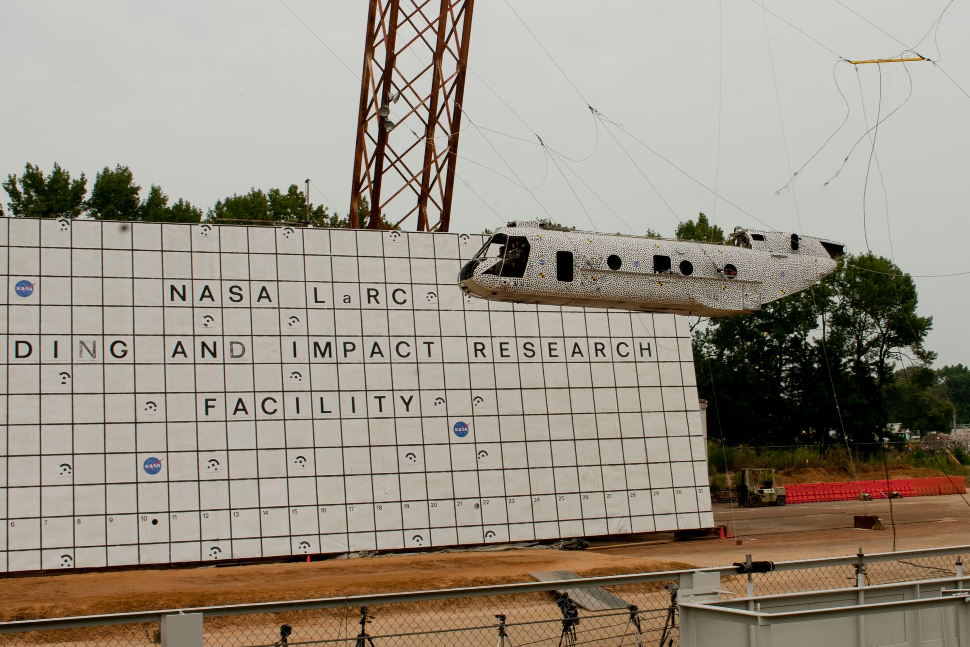 A Sea Knight CH-46E is raised during a controlled aircraft crash at NASA Langley Research Center in Hampton, Va., Aug. 28, 2013. The helicopter, which stretches 45 feet long and weighs more than 13,000 pounds with equipment was lifted 30-feet high with the use of a gantry, a large structure used to launch aircraft. (U.S. Air Force photo by Staff Sgt. Stephanie Rubi/Released) 