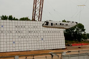 A Sea Knight CH-46E is raised during a controlled aircraft crash at NASA Langley Research Center in Hampton, Va., Aug. 28, 2013. The helicopter, which stretches 45 feet long and weighs more than 13,000 pounds with equipment was lifted 30-feet high with the use of a gantry, a large structure used to launch aircraft. (U.S. Air Force photo by Staff Sgt. Stephanie Rubi/Released) 