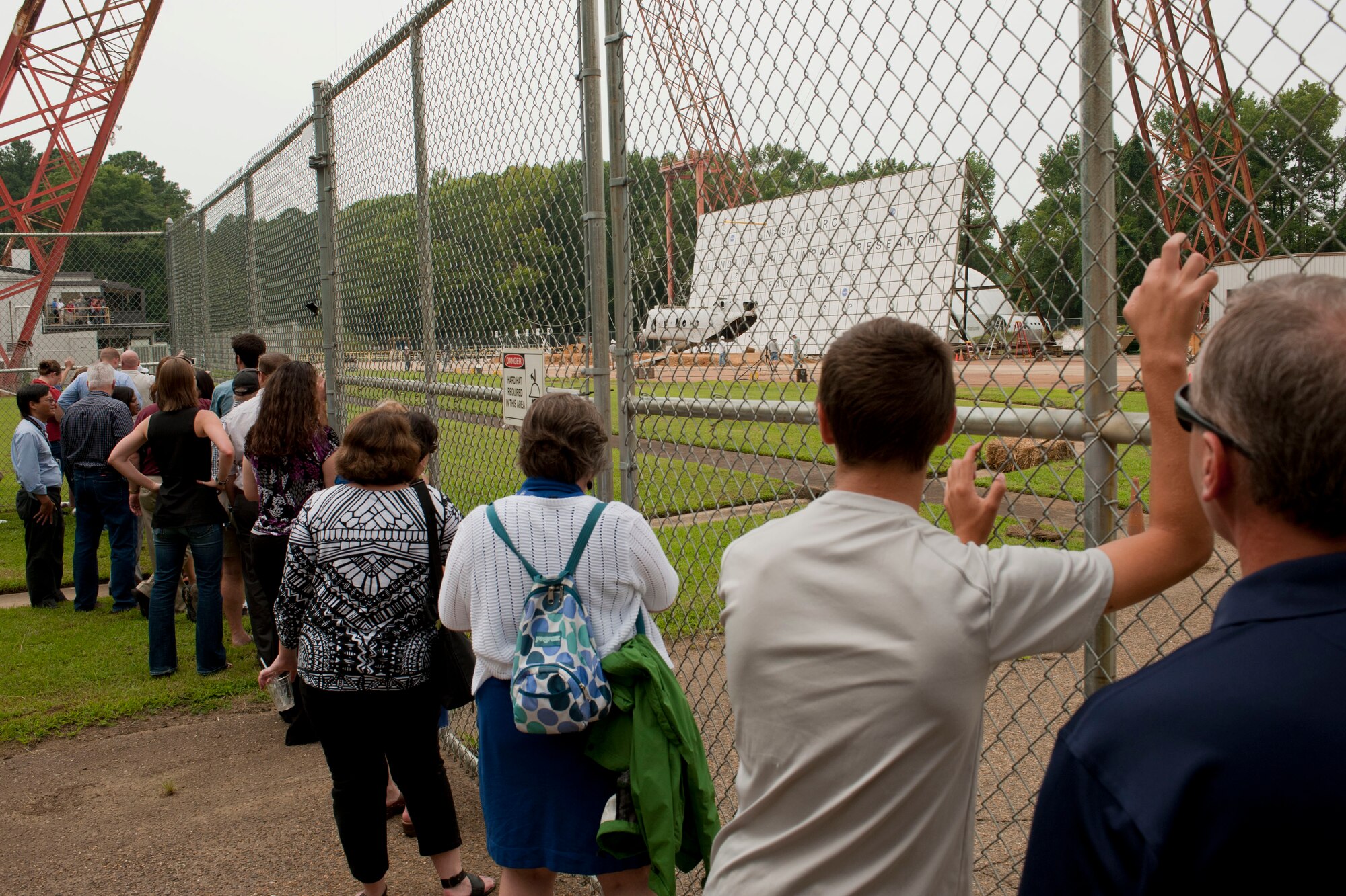 Spectators watch as a Sea Knight CH-46E is raised during a controlled aircraft crash at NASA Langley Research Center in Hampton, Va., Aug. 28, 2013. The Landing and Impact Research facility in Hampton gathered data in order to improve airframe structure and crash protection for passengers in order to make crashes more survivable. (U.S. Air Force photo by Staff Sgt. Stephanie Rubi/Released)