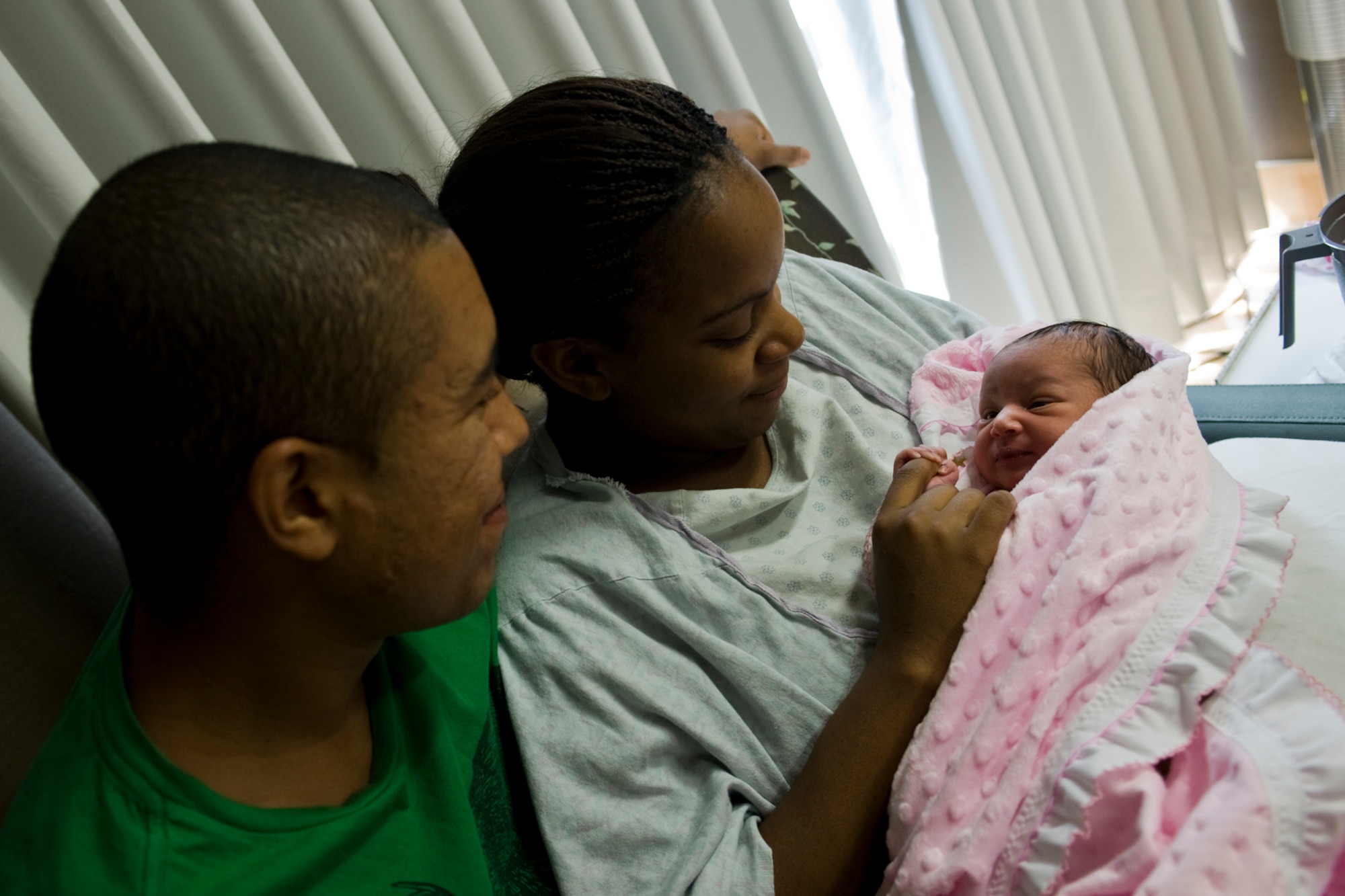 U.S. Navy Petty Officer 2nd Class Jason Jefferson, USS Boise engineering laboratory technician, and his wife, Petty Officer 2nd Class Jessica Jefferson, Norfolk Shipyard Support Activity service mechanical planner, hold their two-day-old daughter, Jenesys, at Langley Air Force Base, Va., Aug. 22, 2013. Jessica delivered her daughter at the Labor & Delivery clinic be monitored there for 48-to-72-hours. (U.S. Air Force photo by Staff Sgt. Stephanie Rubi/Released)