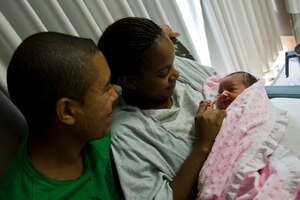 U.S. Navy Petty Officer 2nd Class Jason Jefferson, USS Boise engineering laboratory technician, and his wife, Petty Officer 2nd Class Jessica Jefferson, Norfolk Shipyard Support Activity service mechanical planner, hold their two-day-old daughter, Jenesys, at Langley Air Force Base, Va., Aug. 22, 2013. Jessica delivered her daughter at the Labor & Delivery clinic be monitored there for 48-to-72-hours. (U.S. Air Force photo by Staff Sgt. Stephanie Rubi/Released)