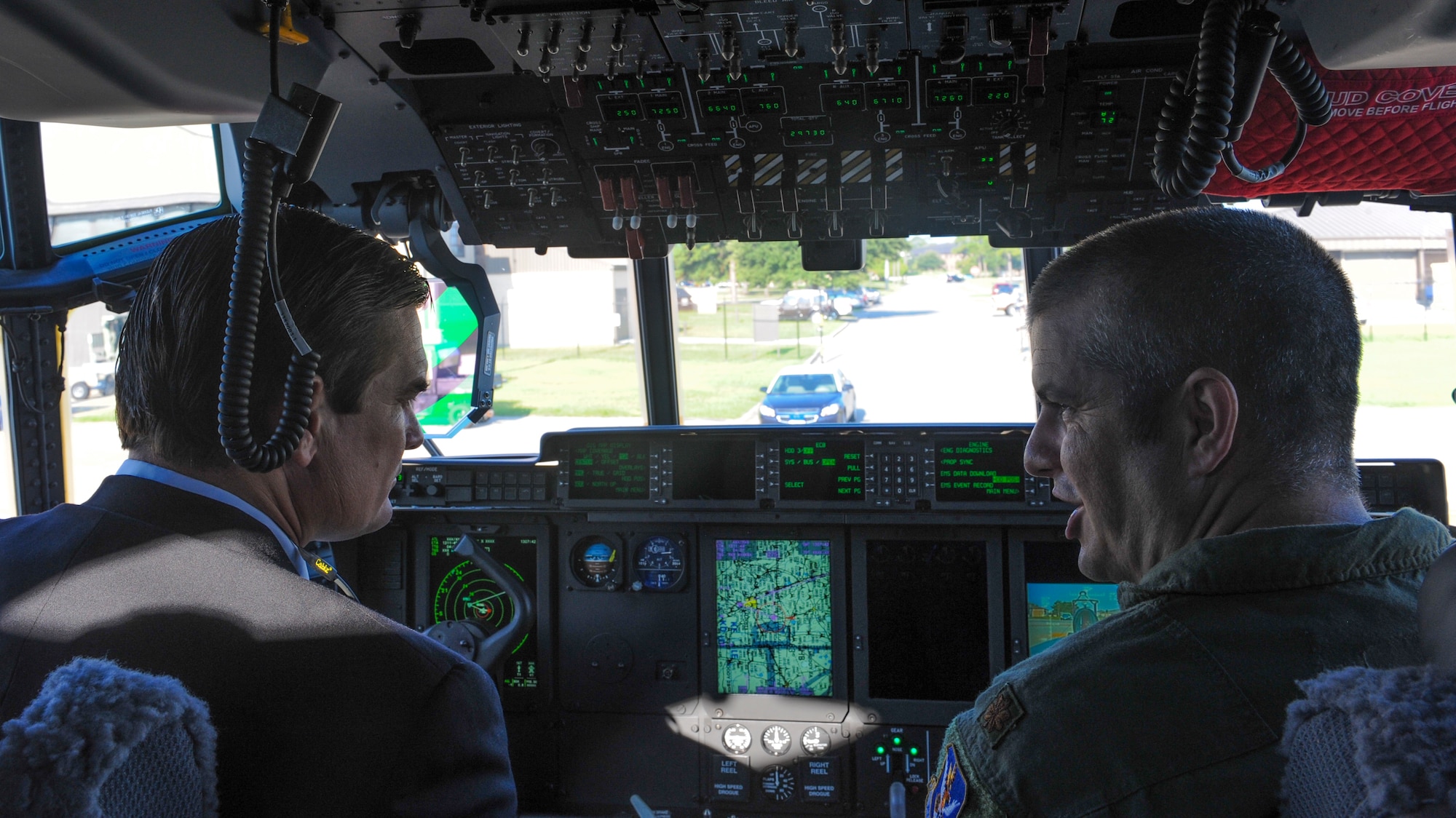 U.S.  Air Force Maj. Eric Lipp (right), 71st Rescue Squadron HC-130J Combat King II pilot, shows U.S. Rep. Austin Scott the inside of a HC-130J cockpit at Moody Air Force Base, Ga., Sept. 4, 2013. Lipp discussed the capabilities of the new HC-130J and how it has been integrated into Moody’s mission.  (U.S. Air Force photo by Airman Alexis Grotz/Released)