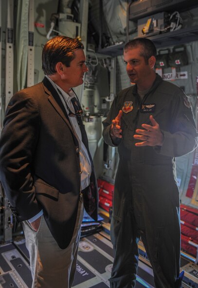 U.S. Air Force Maj. Eric Lipp (right),71st Rescue Squadron HC-130J Combat King II pilot, talks about the features of the aircraft with U.S. Rep. Austin Scott on board an HC-130J at Moody Air Force Base, Ga., Sept. 4, 2013. The HC-130J has only been at Moody since July 19, 2013, but is scheduled to slowly replace the HC-130P Combat Kings currently in use. (U.S. Air Force photo by Airman Alexis Grotz/Released)