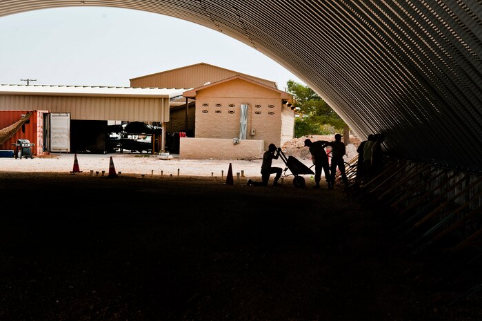 Structures Airmen from the 820th RED HORSE lay concrete against a K-Span building structure during construction Aug. 29, 2013, at Nellis Air Force Base, Nev. The building will be used by the 58th Rescue Squadron for equipment storage. (U.S. Air Force photo by Senior Airman Daniel Hughes)