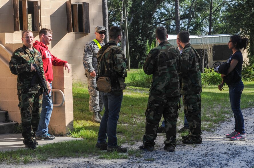 The opposing force talks about what will happen next during a training scenario at the military operations in urban terrain village on Moody Air Force Base, Ga., Aug. 27, 2013. The MOUT village is used to help prepare Airmen to deploy and keep them fit to fight. (U.S. Air Force photo by Airman Alexis Grotz/Released)