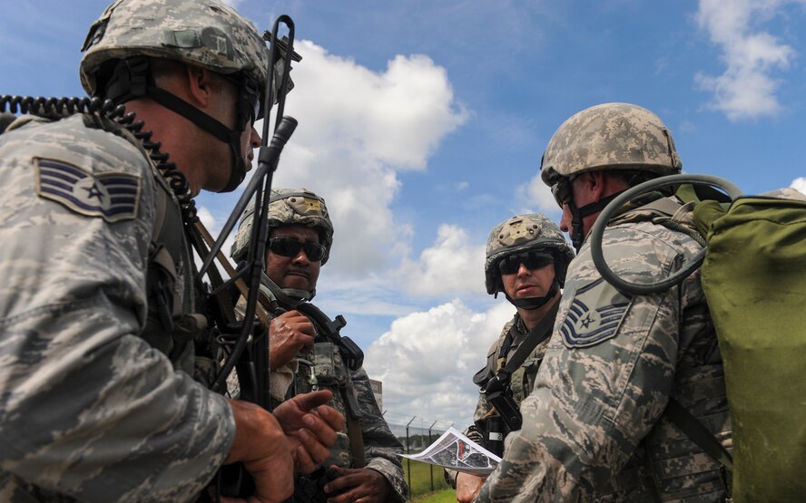 Airmen from the 820th Base Defense Group gather to talk about their route during an exercise mission at Moody Air Force Base, Ga., Aug. 23, 2013. The exercise was a week long and simulated different scenarios Airmen could encounter. (U.S. Air Force photo by Airman Alexis Grotz/Released)