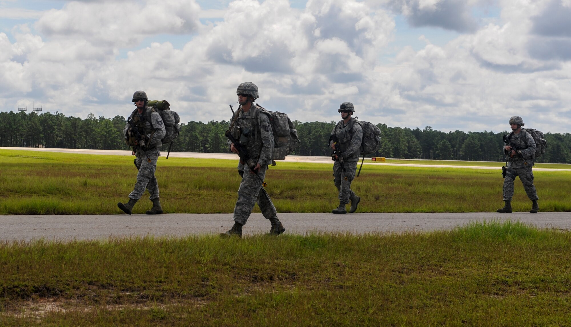 Airmen from the 820th Base Defense Group ruck to complete a mission during a training exercise at Moody Air Force Base, Ga., Aug. 23, 2013. The Airmen started at the flightline and ended the mission with setting up a perimeter around the military operations in urban terrain village. (U.S. Air Force photo by Airman Alexis Grotz/Released)