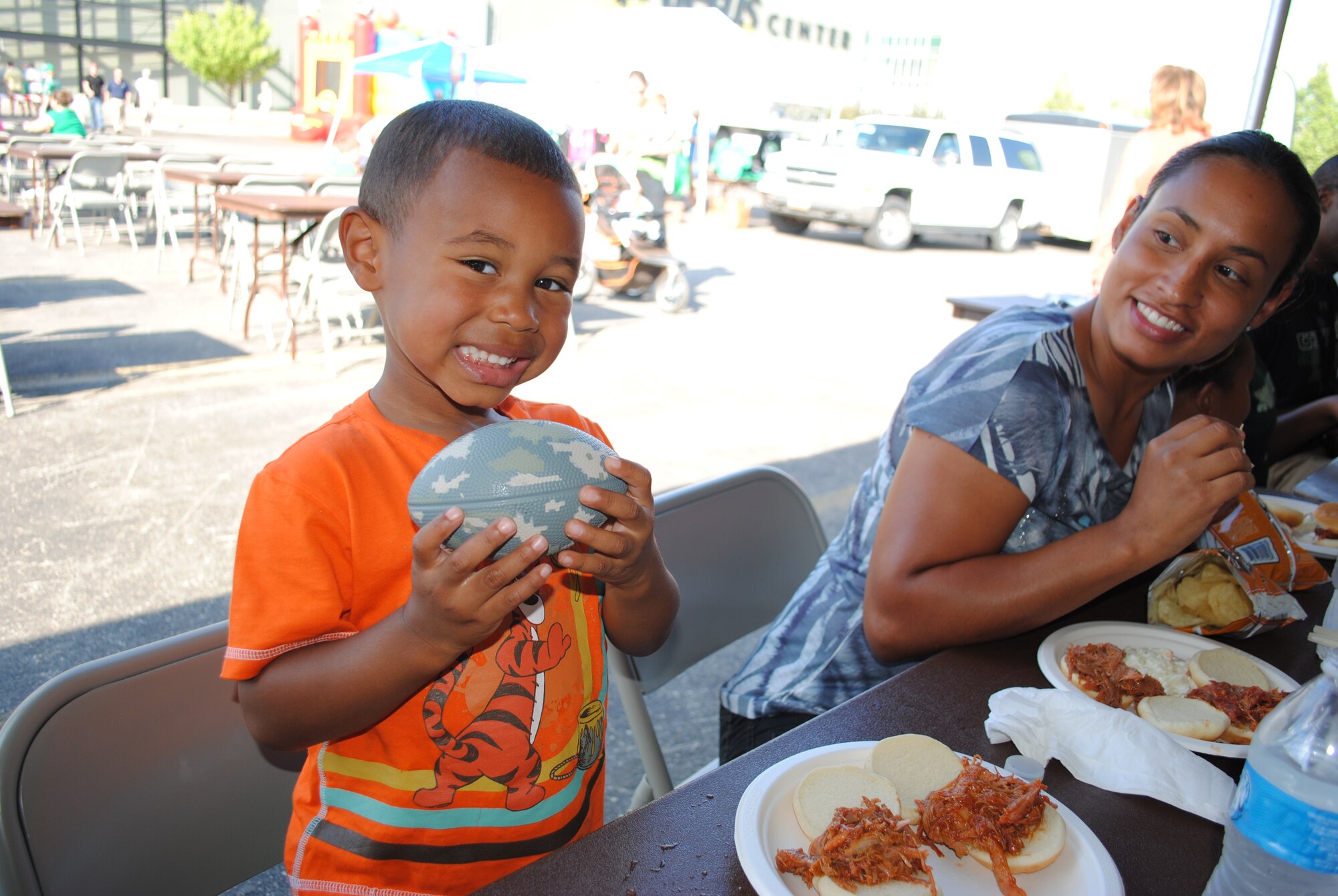 Tech. Sgt. Lemario McPhaul’s three-year-old son, Landon, shows off his brand new Army National Guard foam football during a tailgate party  Aug. 29, 2013, at the Alerus Center Tailgate Village in Grand Forks, N.D. Military members and their families were treated to a free meal and free tickets to the a college football game as part of the 16th Annual Maury Rothkopf Military Appreciation Day sponsored by the University of North Dakota  and the Grand Forks and East Grand Forks, Minn., Chambers of Commerce. (U.S. Air Force photo/Staff Sgt. Luis Loza Gutierrez) 