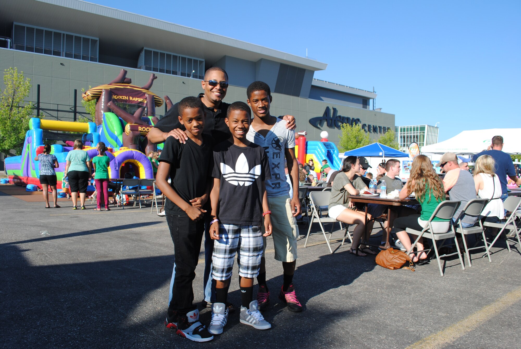 Chaplain (Maj.) Steven Dabbs from the 319th Air Base Wing and his three sons pose for a group photo before taking part in the festivities of the 16th Annual Maury Rothkopf Military Appreciation Day, Aug. 29, 2013, sponsored by the University of North Dakota and the Grand Forks and East Grand Forks, Minn., Chambers of Commerce. Chaplain Dabbs described the event as a great opportunity for parents to spend quality time with their families. (U.S. Air Force photo/Staff Sgt. Luis Loza Gutierrez) 