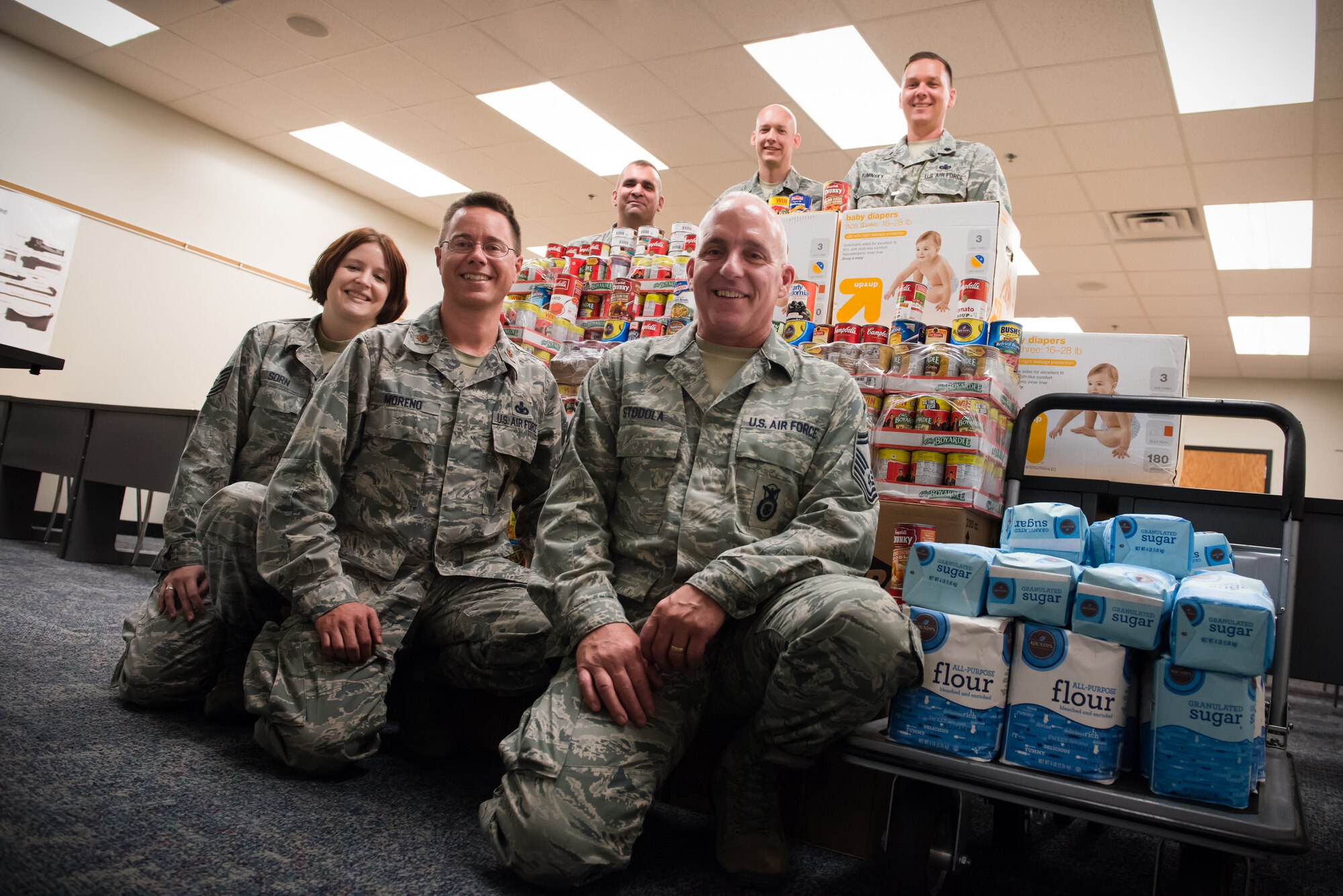 Members of the 934th Security Forces Squadron contributed about 1400 pounds of food and supplies to the Feds Feed Families Campaign this year. Pictured from bottom left to right: Tech. Sgt. Lori Sorn, Maj. Leo Moreno, Senior Master Sgt. Mark Stodola; from top left to right: Tech. Sgt. Joe Boncher, Senior Master Sgt. Nate Dillner and Lt. Col. Ted Ruminsky. (Air Force Photo/Keith Langsdorf)