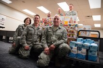 Members of the 934th Security Forces Squadron contributed about 1400 pounds of food and supplies to the Feds Feed Families Campaign this year. Pictured from bottom left to right: Tech. Sgt. Lori Sorn, Maj. Leo Moreno, Senior Master Sgt. Mark Stodola; from top left to right: Tech. Sgt. Joe Boncher, Senior Master Sgt. Nate Dillner and Lt. Col. Ted Ruminsky. (Air Force Photo/Keith Langsdorf)