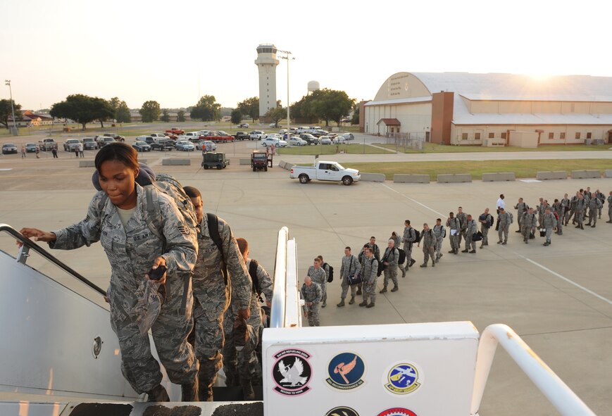 Barksdale Airmen board an aircraft departing for Andersen Air Force Base, Guam, on Barksdale Air Force Base, La., Aug. 30, 2013. The 20th and 96th Bomb Squadrons send Airmen and B-52H Stratofotress bombers to Guam in support of the Continuous Bomber Presence mission in the pacific region. (U.S. Air Force photo/Senior Airman Benjamin Gonsier)