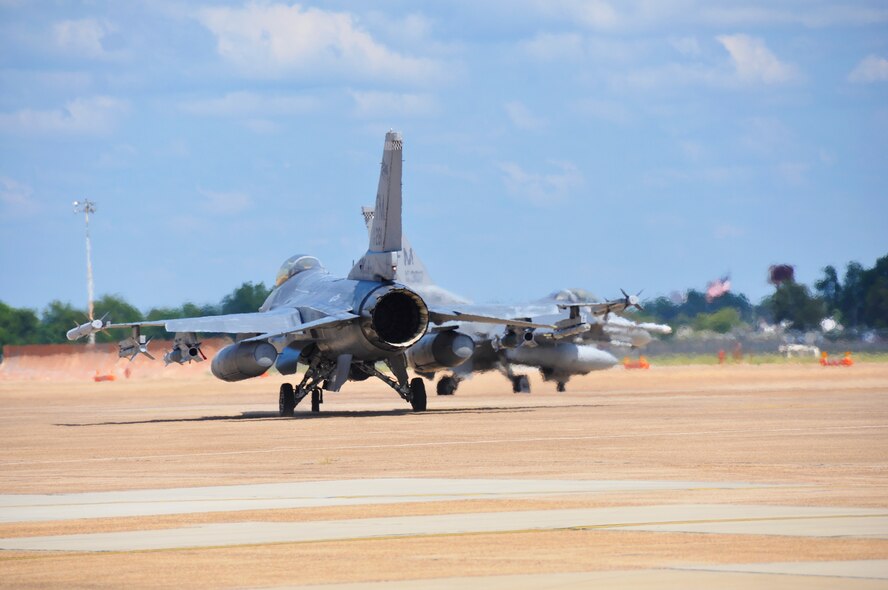 Two F-16's from Homestead ARB taxi to the runway for take off at Barksdale AFB during Operation Green Flag, Aug. 26. (U.S. Air Force photo/ Tech. Sgt. Lou Burton)