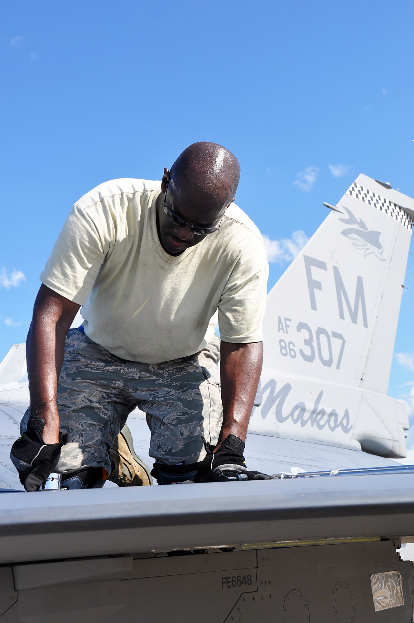 Tech. Sgt. Leon Pennington, 482nd FW crew chief, repairs an F-16 fuel tank at Barksdale AFB during Operation Green Flag, Aug. 25. (U.S. Air Force photo/ Tech. Sgt. Lou Burton)