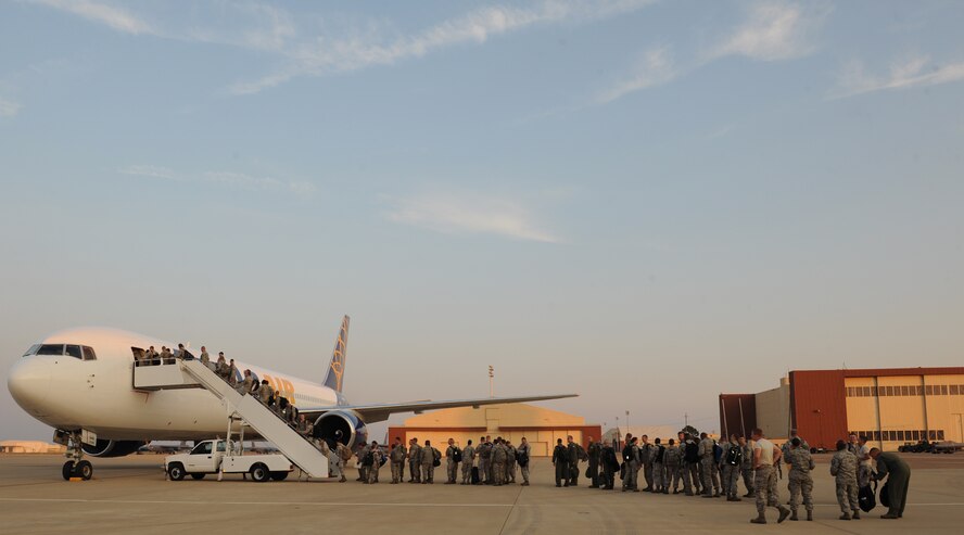 Barksdale Airmen board an aircraft departing for Andersen Air Force Base, Guam, on Barksdale Air Force Base, La., Aug. 30, 2013. More than 200 Airmen deployed to Guam to support the Continuous Bomber Presence mission in the pacific region. (U.S. Air Force photo/Senior Airman Benjamin Gonsier)