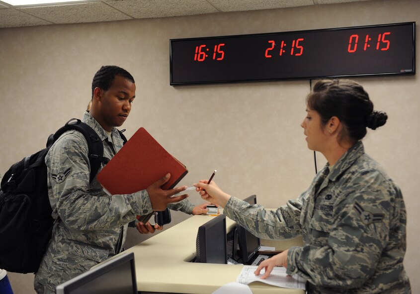 Airman 1st Class Sudarien Smith, 20th Aircraft Maintenance Unit crew chief, is properly identified by Airman 1st Class Ashley Castro, 2nd Logistics Readiness Squadron, before moving to the baggage check station on Barksdale Air Force Base, La., Aug. 30, 2013. The Airmen of the 2nd Bomb Wing must maintain a level of readiness in order to provide continuous combat capability with stability, predictability and safety in all missions, whether home or abroad. (U.S. Air Force photo/Senior Airman Benjamin Gonsier)