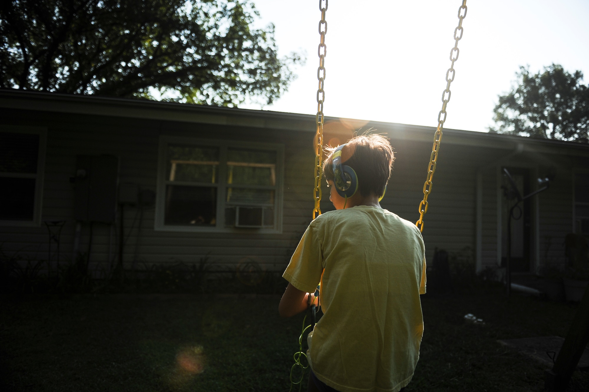 Morgan Jungk swings in her backyard Aug. 24, 2013, in Jacksonville, Ark. Morgan is the 14-year-old daughter of Master Sgt. Beth Jungk, a 19th Communications Squadron plans and programs manager, and suffers from autism, kabuki syndrome, severe epilepsy and other ailments. Swinging while listening to music is her favorite activity.(U.S. Air Force photo by Staff Sgt. Jake Barreiro)