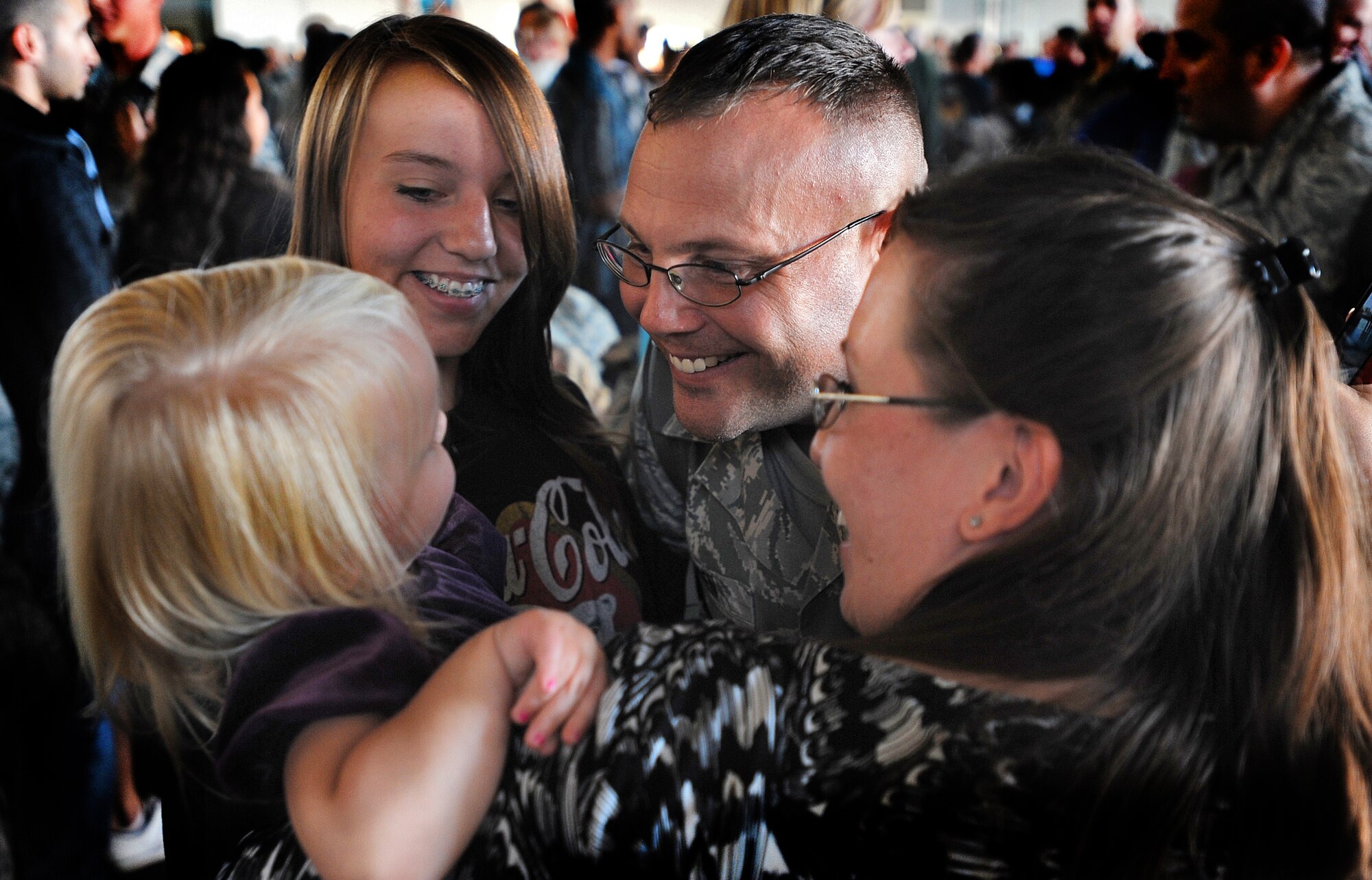 An Airman greets his family after returning home from a 5-month deployment to Anderson Air Force Base, Guam, Sept. 1. More than 200 Airmen from the 5th Bomb Wing returned home Sunday afternoon. (U.S. Air Force photo/Senior Airman Jose L. Hernandez)