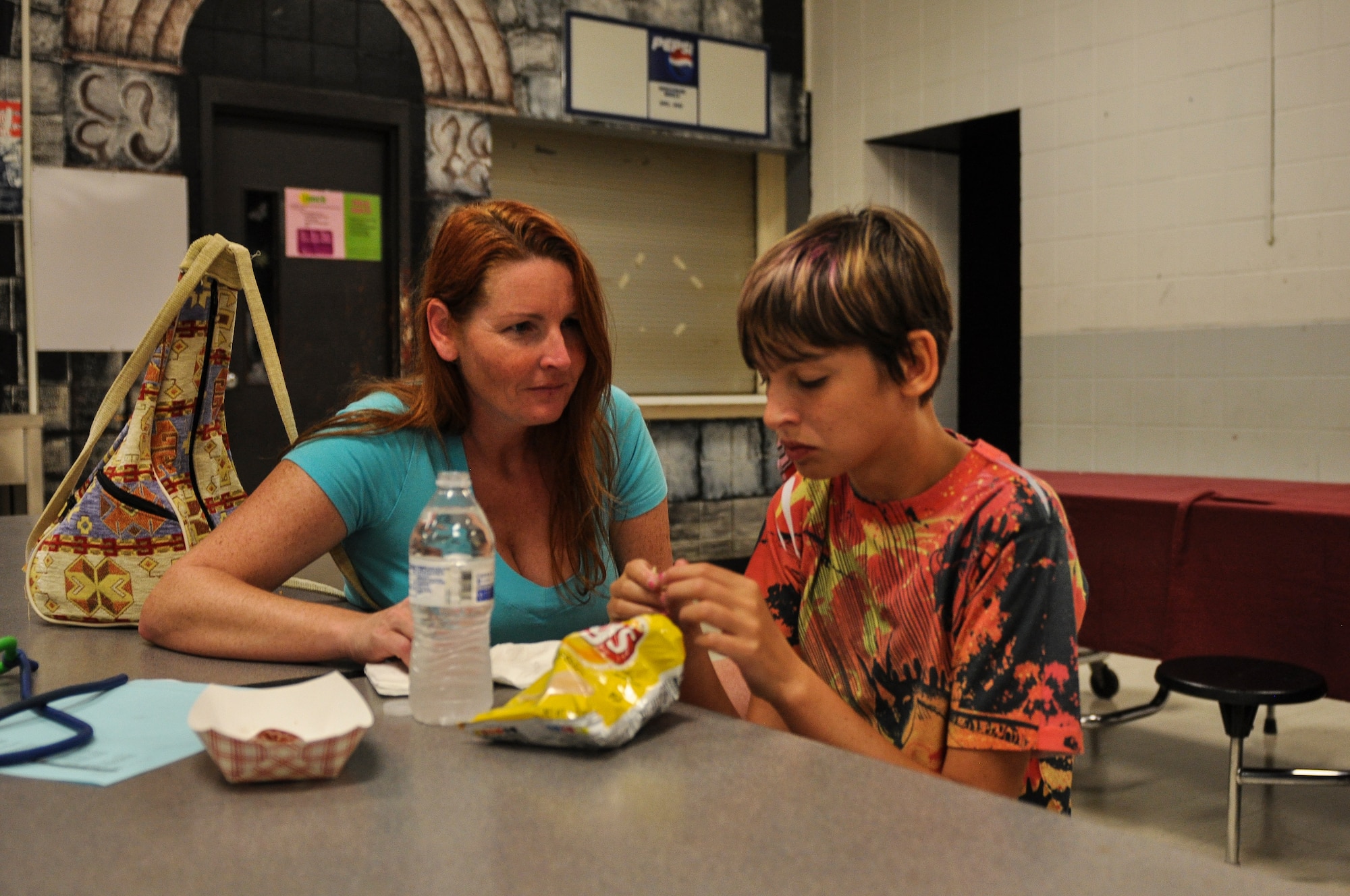 Morgan Jungk, daughter of Master Sgt. Beth Jungk, a 19th Communications Squadron plans and programs manager, eats by her mother during orientation night Aug. 15, 2013, at Northwood Middle School in Gravel Ridge, Ark. Beth tried to acclimate Morgan to the idea of going back to school by taking her to her classrooms and meeting her teachers. (U.S. Air Force photo by Staff Sgt. Jake Barreiro)
