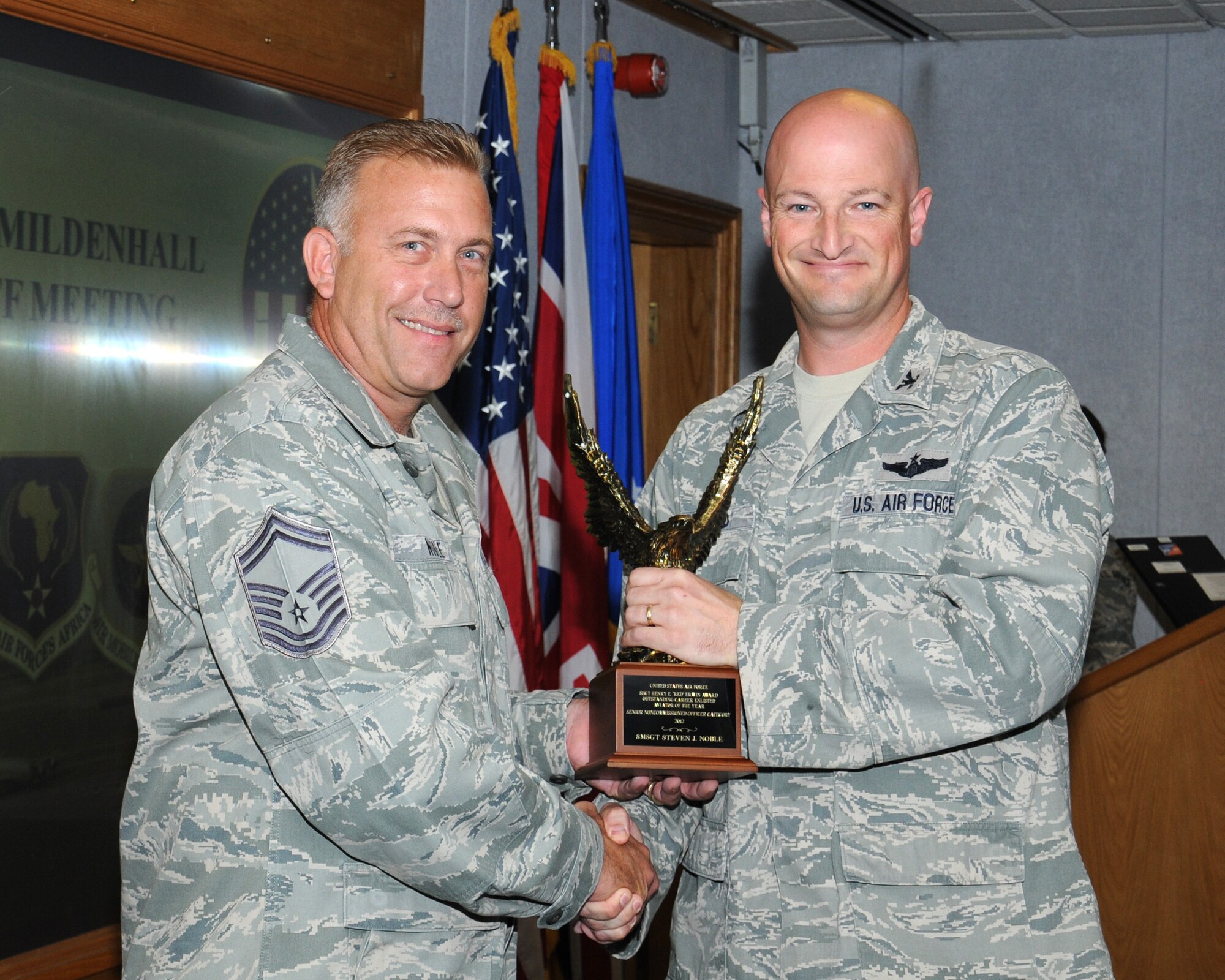 U.S. Air Force Col. Christopher Ireland, right, 352nd Special Operations Group commander, awards U.S. Air Force Senior Master Sgt. Steven Noble, 352nd Special Operations Support Squadron  superintendent from Sacramento, Calif., a U.S. Air Force Staff Sgt. Henry E. “Red” Erwin Outstanding Career Enlisted Aviator of the Year Award Sept. 4, 2013, on RAF Mildenhall, England. Noble won the award for outstanding accomplishments in the aircrew operations career fields with significant results, major mission impact, demonstration of outstanding leadership and professional qualities, and superior contributions to the roles and mission of the U.S. Air Force. (U.S. Air Force photo by Gina Randall/Released)