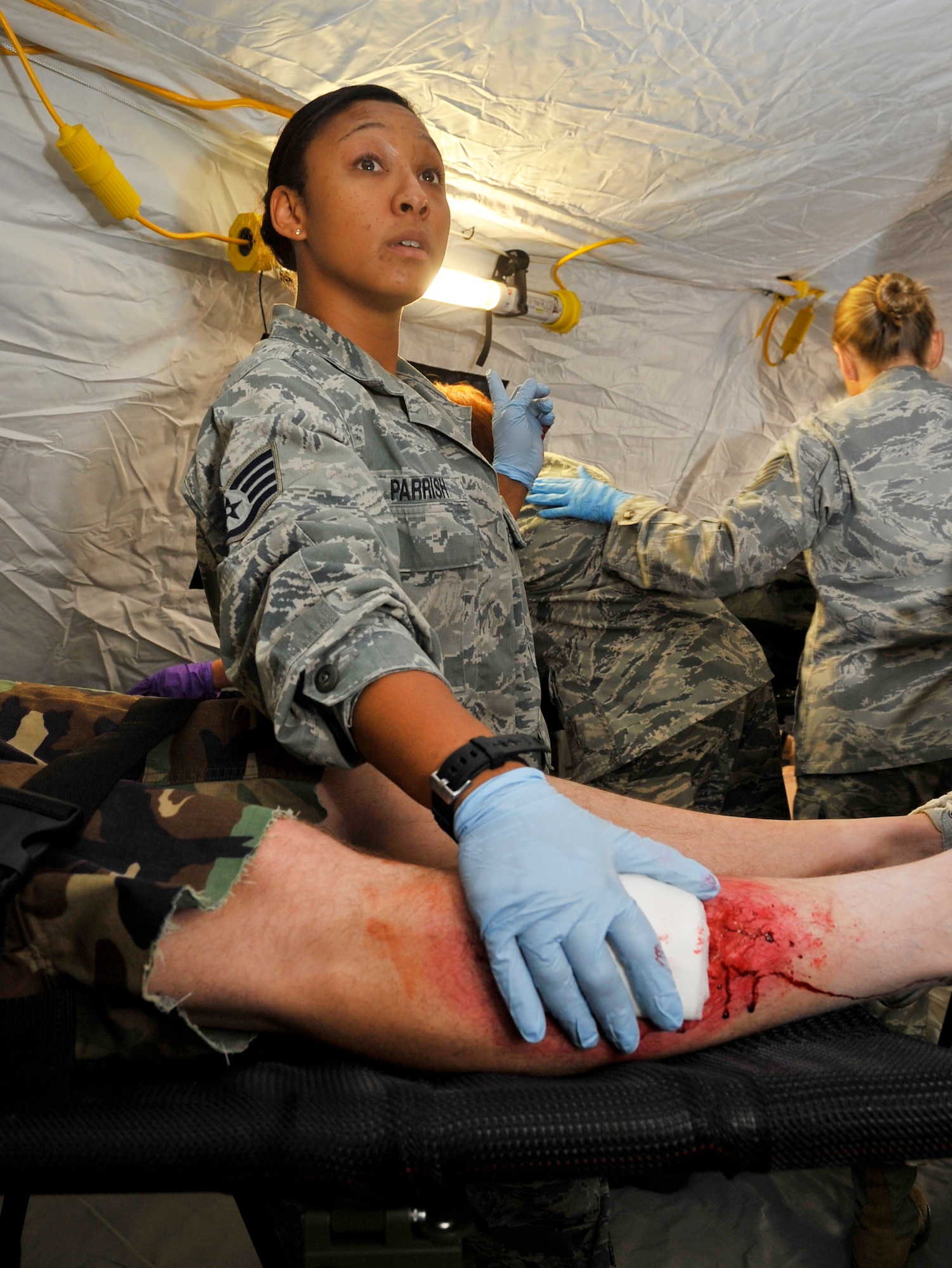 U.S. Air Forces in Europe and Air Forces Africa medical unit member patch-up the leg of a wounded patient during Expeditionary Medical Support training Aug. 28, 2013, Ramstein Air Base, Germany. EMEDS training is conducted to prepare Airmen for humanitarian missions. (U.S. Air Force photo/Airman Dymekre Allen) 