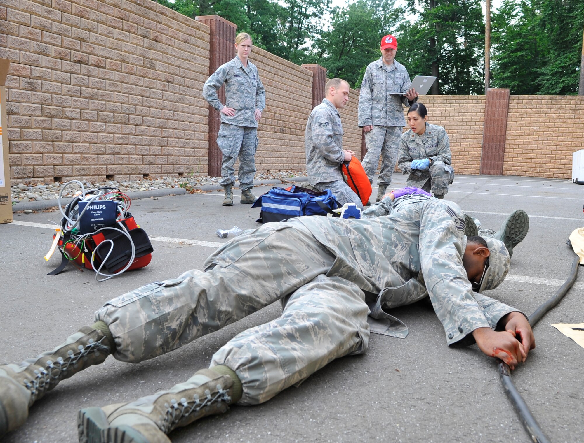 U.S. Air Forces in Europe and Air Forces Africa medical unit member simulates being electrocuted during Expeditionary Medical Support training Aug. 28, 2013, Ramstein Air Base, Germany. EMEDS training is conducted to prepare Airmen for humanitarian missions. (U.S. Air Force photo/Airman Dymekre Allen)