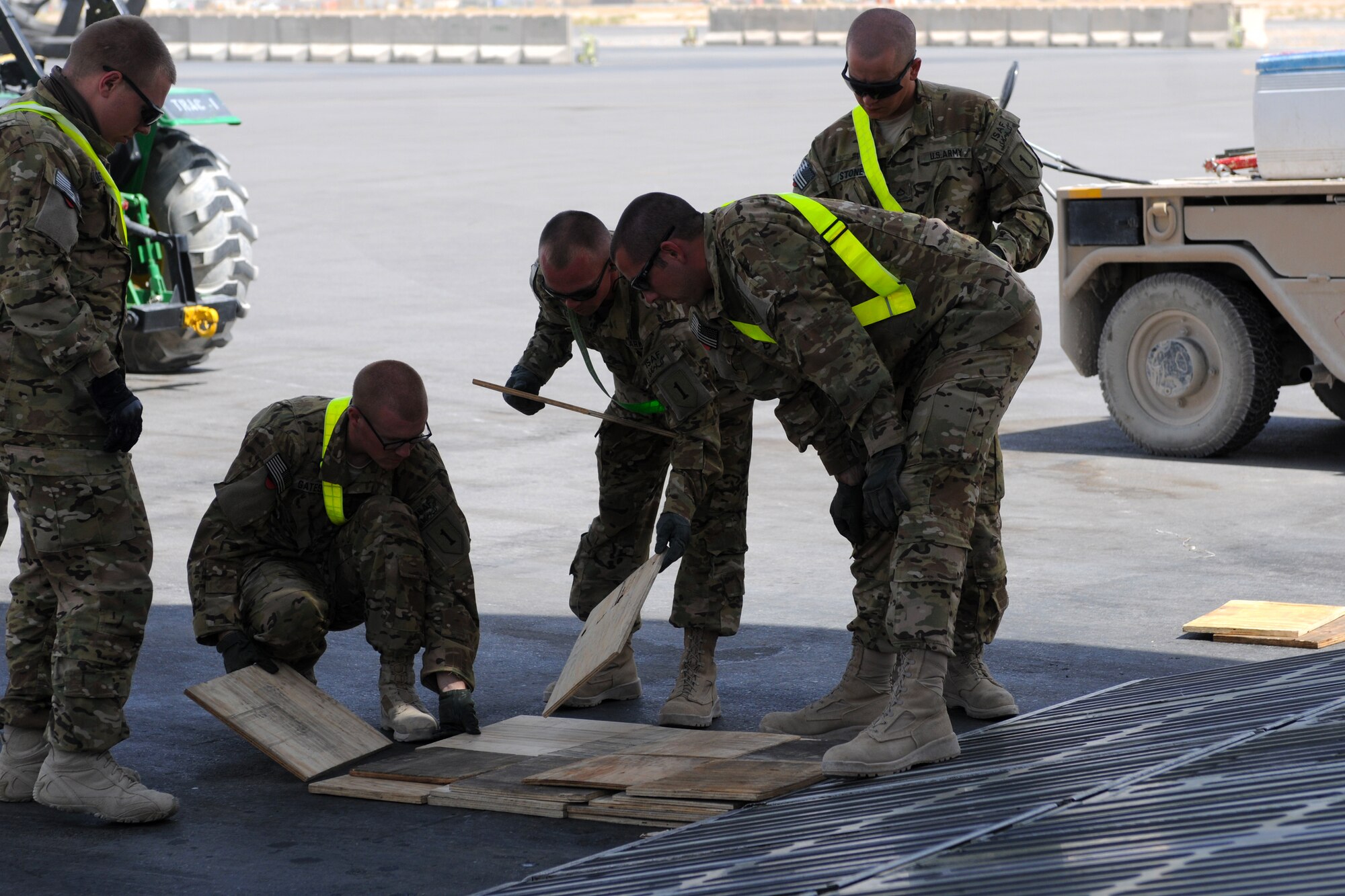 Soldiers from Bravo Company, 601st Aviation Support Battalion, 1st Combat Aviation Brigade, place shoring on the ramp of a C-5M Super Galaxy at Kandahar Airfield, Afghanistan, Aug. 24, 2013. The shoring was necessary for offloading two Chinook helicopters from the Super Galaxy. (U.S. Air Force photo/Capt. Brian Maguire)