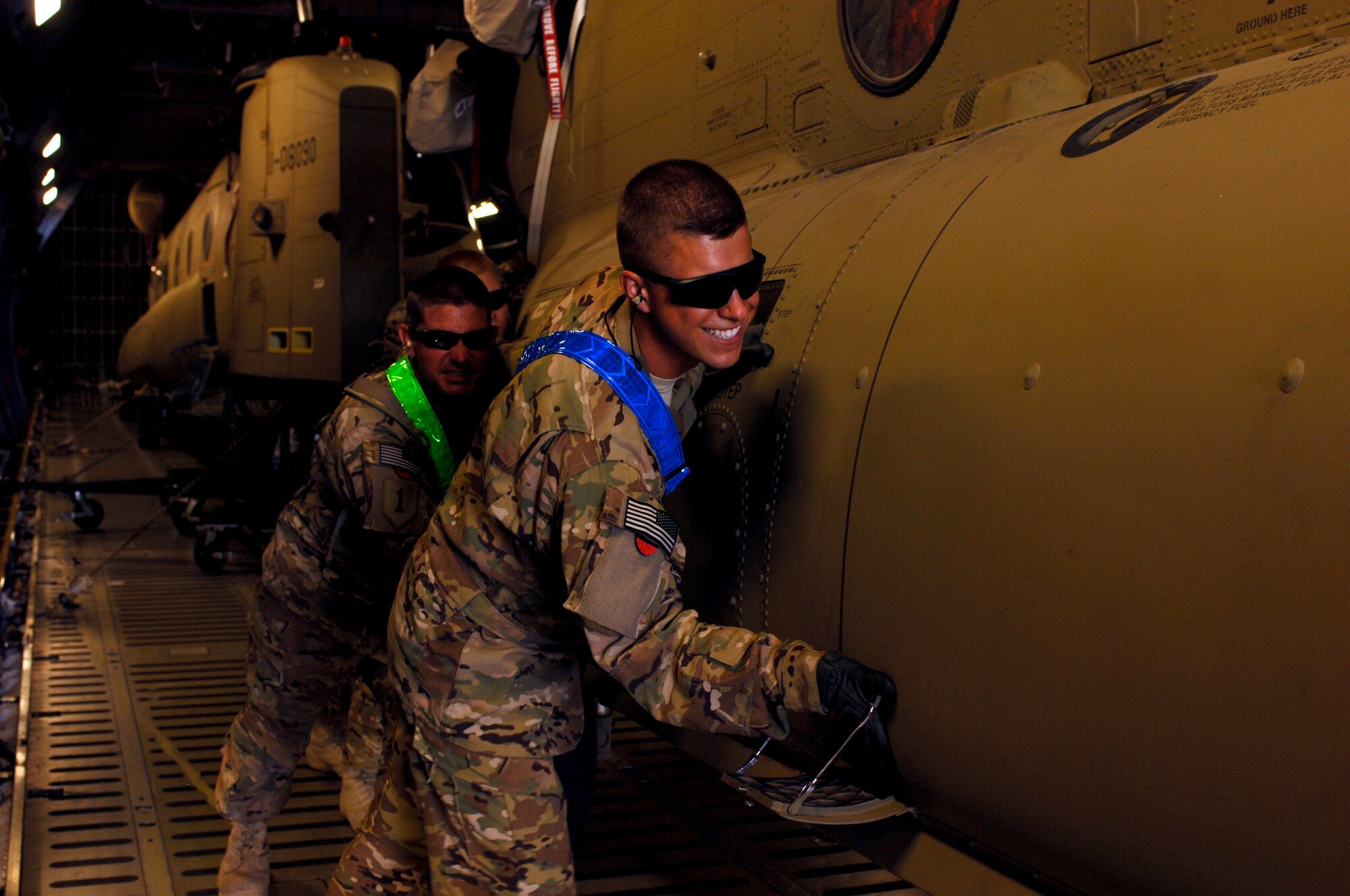 Soldiers from Bravo Company, 601st Aviation Support Battalion, 1st Combat Aviation Brigade, unload a Chinook helicopter from a C-5M Super Galaxy from Dover Air Force Base, Del. Airmen used C-5 Galaxys to move more than 120 Chinook and Black Hawk helicopters during a multi-modal mission that lasted nearly three weeks at Kandahar Airfield, Afghanistan. (U.S. Air Force photo by Senior Airman Jack Sanders)