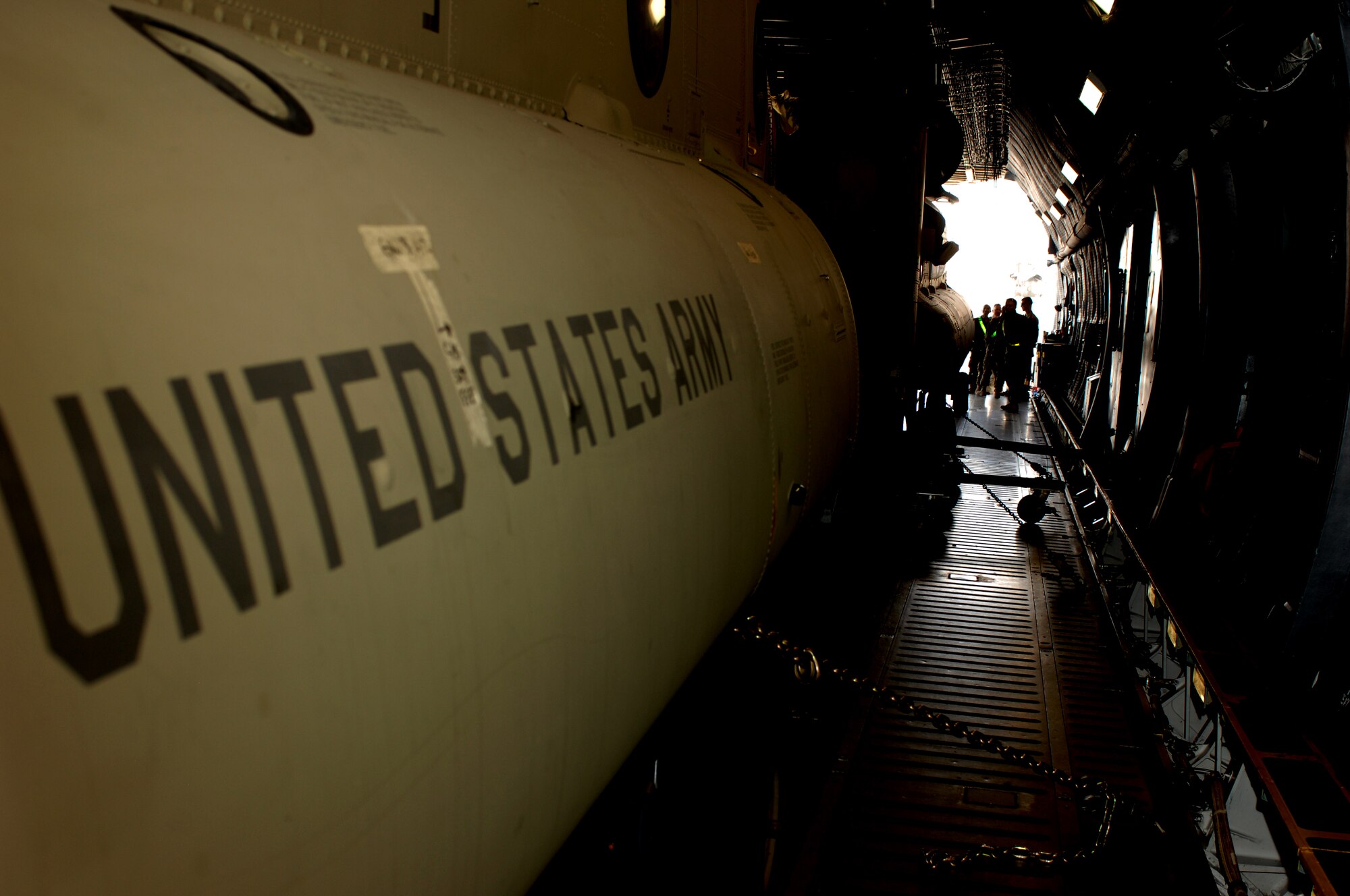 Soldiers from Bravo Company, 601st Aviation Support Battalion, 1st Combat Aviation Brigade wait to unload two Chinook helicopters from a C-5M Super Galaxy at Kandahar Airfield, Afghanistan. The 1st Combat Aviation Brigade will be replacing the 3rd Combat Aviation Brigade here. (U.S. Air Force photo by Senior Airman Jack Sanders)