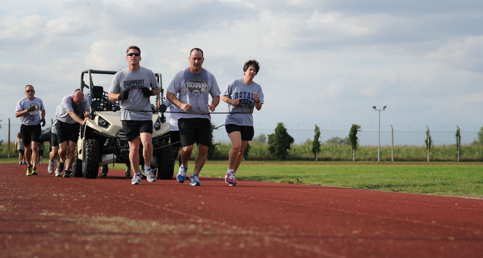 Members of Team Eagles, composed of base unit commanders, pull an all-terrain vehicle during the Chiefs vs. Eagles Monster Mash at Heritage Park on RAF Mildenhall, England. Challenges included a zodiac carry, litter carry, forklift tire flip and the entire event covered a distance of almost 3 miles. The monster mash promoted teamwork, leadership and followership among base leadership. (U.S. Air Force photo by Airman 1st Class Preston Webb/Released)