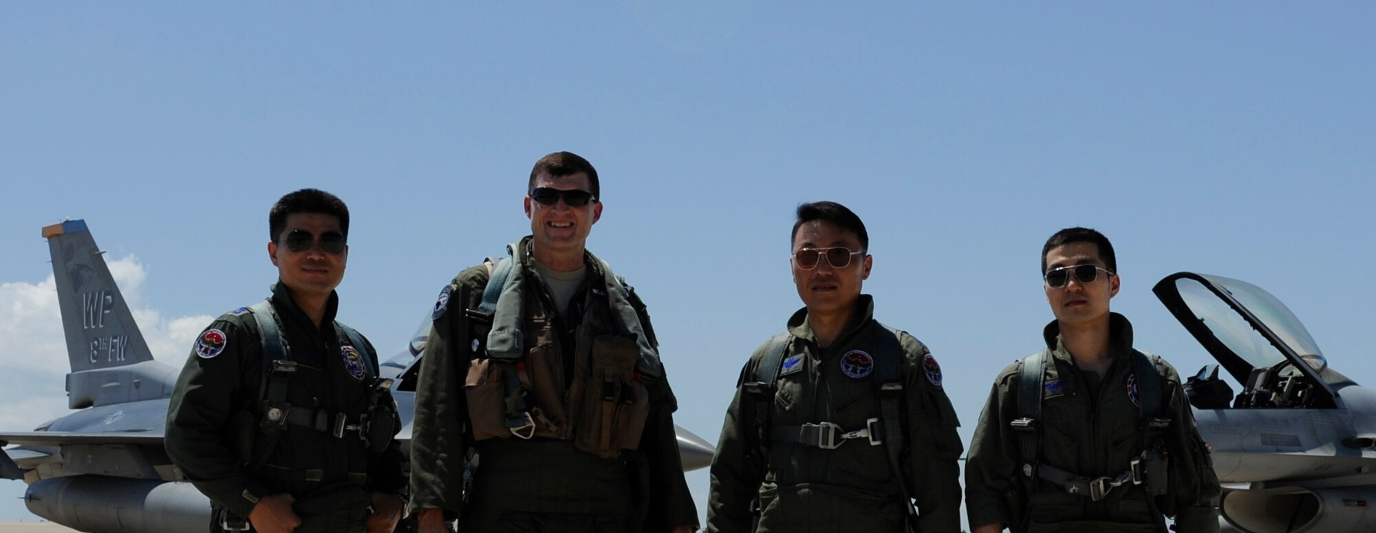 KUNSAN AIR BASE, Republic of Korea -- Colonel S. Clinton Hinote, 8th Fighter Wing commander, center left, and Republic of Korea air force Col. Min-Oh Seo, 38th Fighter Group commander, pose for a photo with their wingmen after a friendship flight Aug. 14, 2013. The formation, which included leadership from the 8th FW and 38th FG, flew to several landmarks around Gunsan, ROK. (U.S. Air Force photo by Senior Airman Armando A. Schwier-Morales/ Released)