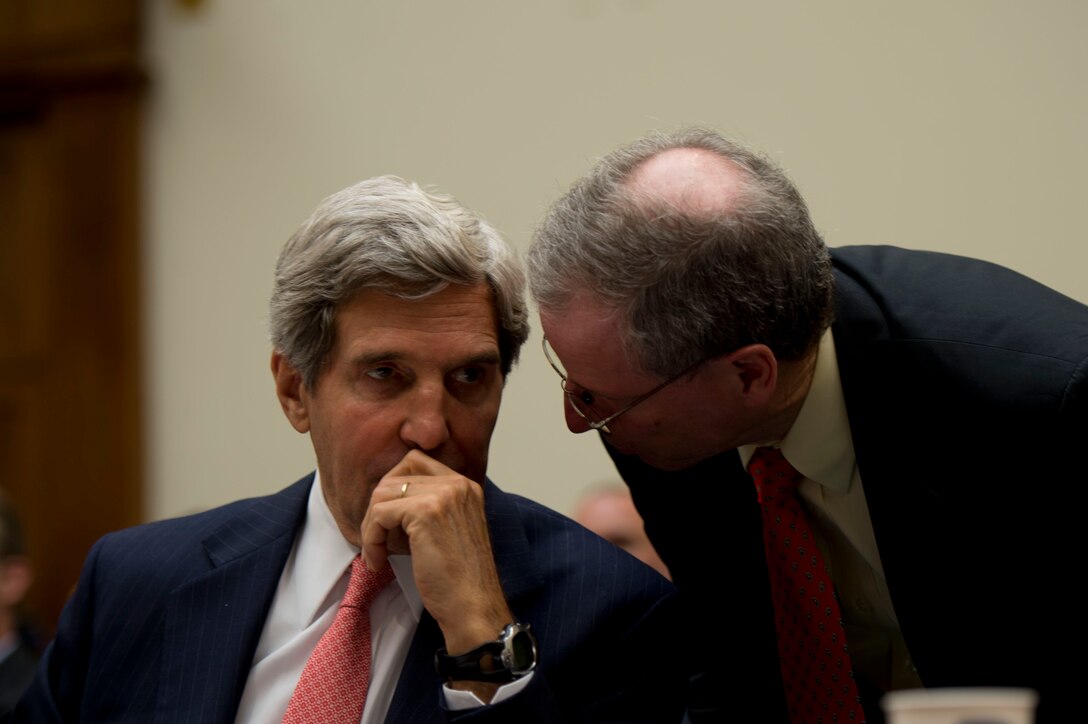 Secretary of State John F. Kerry speaks with U.S. Ambassador to Syria Robert Stephen Ford during testimony before the House Foreign Affairs Committee in Washington, D.C., Sept. 4, 2013.