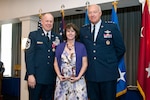 Lt. Gen. Harry Wyatt, Director of the Air National Guard, National Guard Bureau, Washington, D.C., presents the Chief of Staff of the Air Force award for exceptional public service to Monique Muncy, wife of Chief Master Sgt. Christopher E. Muncy, Command Chief Master Sergeant of the Air National Guard, National Guard Bureau, Washington, D.C., during Chief Muncy's retirement luncheon at Joint Base Anacostia-Bolling. Muncy retired after thirty-five years of service to his country and held the position of Command Chief Master Sergeant of the Air National Guard since May 2009.