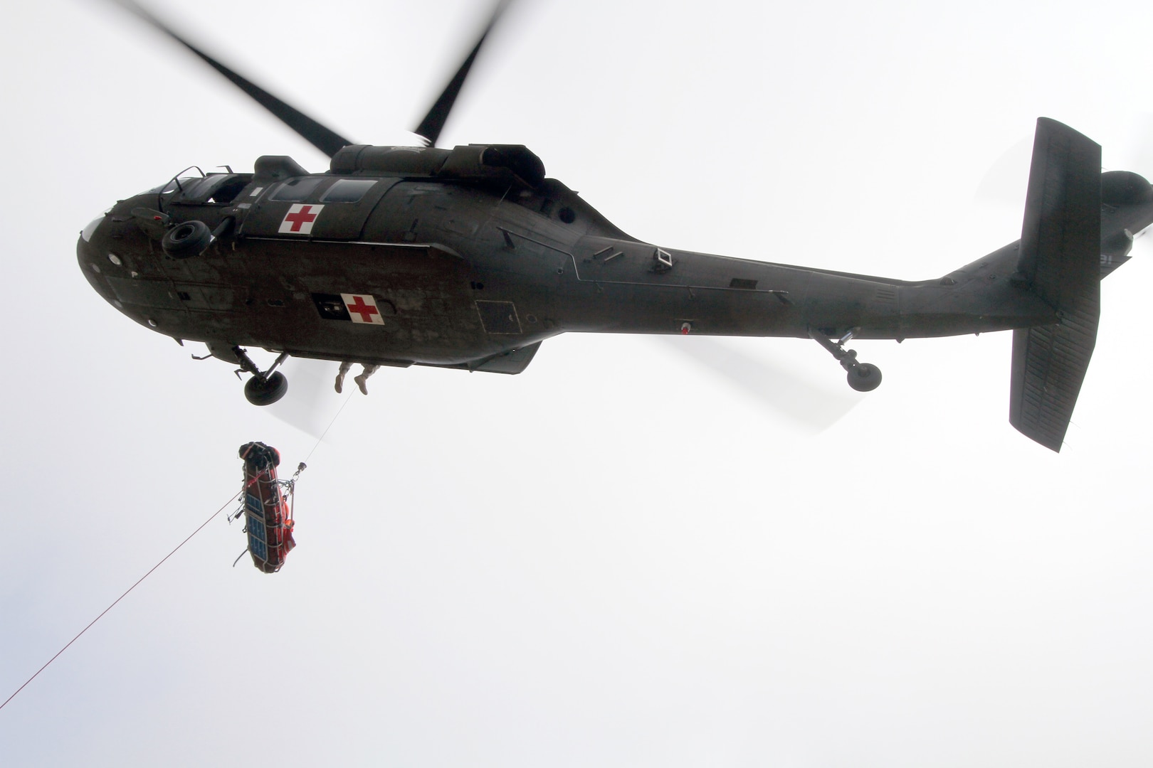 Military rescuers joined civilian crews in saving a fallen climber in Colorado but the effort left one National Guard member with a broken lower leg.