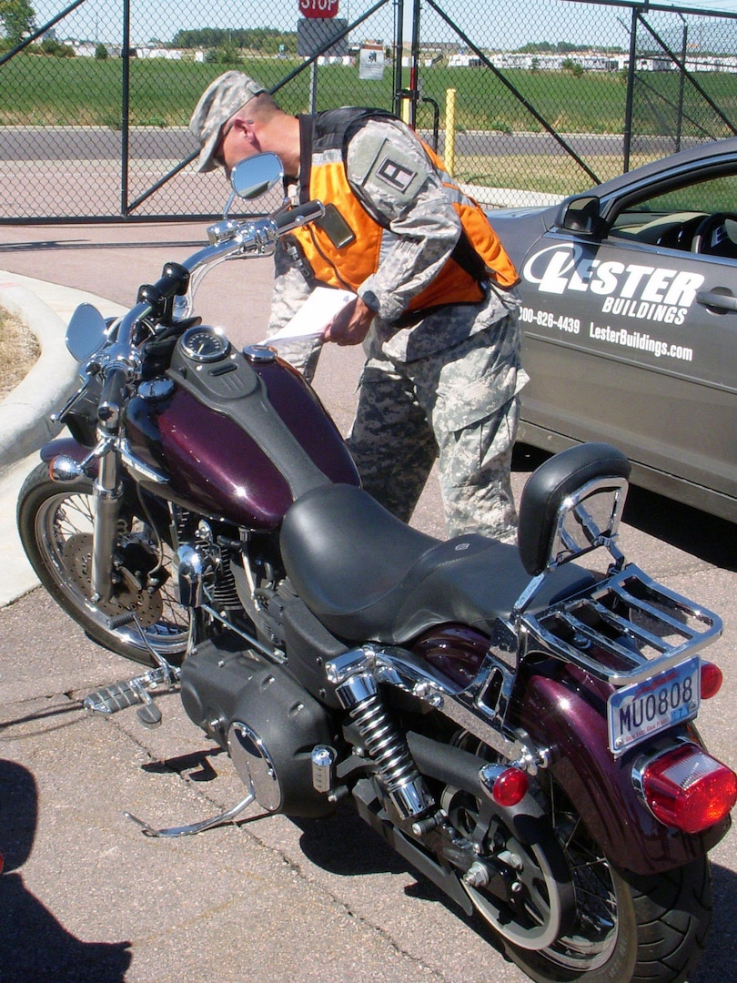 Sgt. 1st Class Wyatt A. Vanzee, 5th Armored Brigade, Division West, performs an inspection of his Soldier’s motorcycle using the Tires and Wheels, Cables and Control, Lights, Oil and Fluids, Chassis and Sidestand pre-ride checklist at the recent Task Force Coyote safety ride at Sioux Falls, S.D.