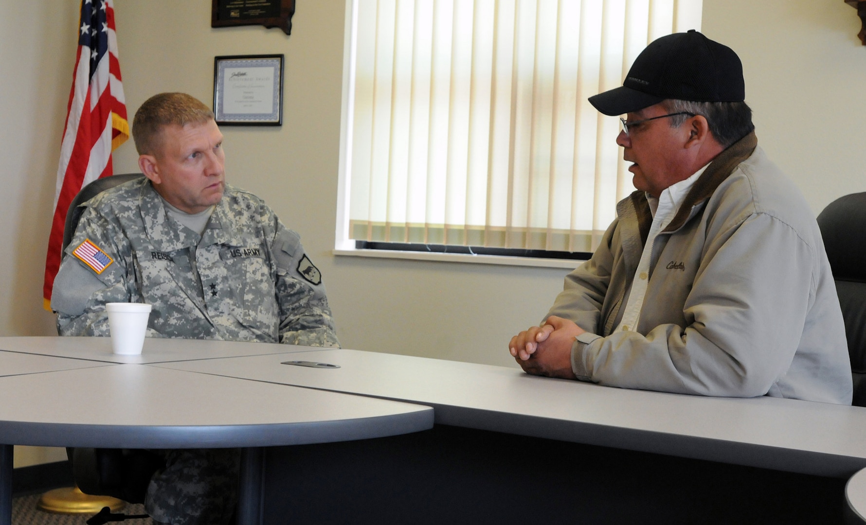 Richard Leasure, environmental director and emergency manager for the Yankton Sioux Tribe, visits with Maj. Gen. Tim Reisch, adjutant general of the South Dakota National Guard, to discuss partnership opportunities.