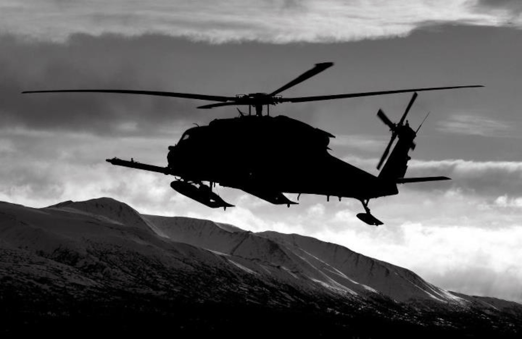 An Alaska Air National Guard HH-60 Pave Hawk helicopter flies over Alaska during a winter training mission.