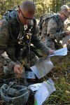 Army Sgt. Matthew Howard, left, an artillery crewmember with Battery C, 2nd Battalion, 142nd Fires Brigade, Arkansas Army National Guard, and Army Sgt. Mark Fuggiti, a supply specialist with Company C, Recruiting and Retention Battalion, Pennsylvania Army National Guard, open their maps during the 2012 Department of the Army Best Warrior Competition at Fort Lee, Va., Oct. 16, 2012. Howard went on to finish the course first among the 24 competitors.