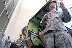 Army Capt. Kevin Schierholz explains features of the M997A3 Humvee ambulance – the newest ambulance system throughout the Army – during a ceremony and presentation at the Army National Guard Readiness Center in Arlington, Va., Wednesday, Oct. 17, 2012.