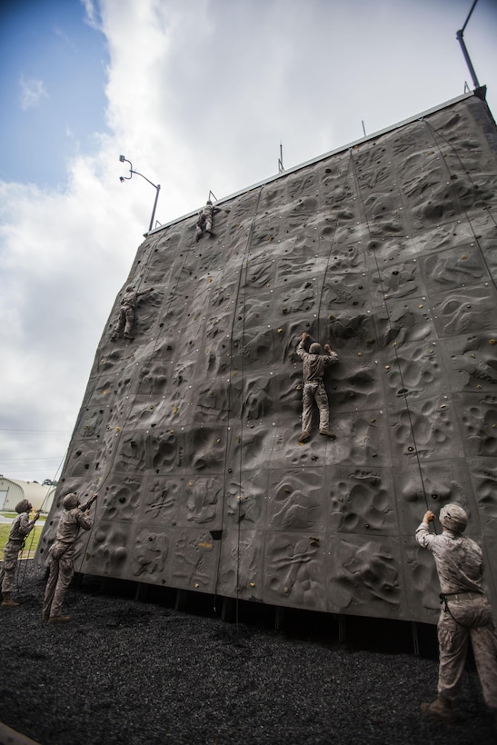 Battalion Landing Team 1st Battalion, 6th Marine Regiment, 22nd Marine Expeditionary Unit (MEU), Marines scale a rock wall at Marine Corps Base Camp Lejeune, N.C., July 16, 2013. More than 20 battalion Marines completed the rigorous six-week assault climbers course, which culminated in three weeks of mountainous-terrain training at Camp Dawson, W.Va. The MEU is scheduled to deploy in early 2014 to the U.S. 5th and 6th Fleet areas of responsibility with the Bataan Amphibious Ready Group as a sea-based, expeditionary crisis response force capable of conducting amphibious missions across the full range of military operations. (U.S. Marine Corps photo by Sgt. Austin Hazard/Released)