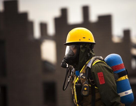 Cpl. Jerry H. Robinson, a search and rescue Marine with the Chemical Biological Incident Response Force, walks through a simulated disaster area searching for role-playing victims during Exercise Scarlet Response in Guardian Center, Ga., Aug. 17. The Marines responded to a simulated nuclear blast, which stopped traffic and contaminated the town during a 48-hour exercise. (U.S. Marine Corps photo by Pfc. Dylan Bowyer/Released)