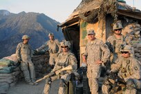 Capt. Peter Shinn of Omaha smiles with Soldiers at Outpost Mace in Kunar Province, Afghanistan, Dec. 20, 2010. Shinn won an Emmy for videography in Afghanistan.