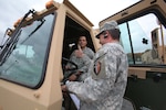 Staff Sgt. Joseph Wolf, right, gives the thumbs up to Spc. Angel Fuentes, both with the 250th Brigade Support Battalion, New Jersey Army National Guard, as the unit prepares to move their medium tactical vehicles for Hurricane Sandy at the National Guard Armory in Lawrenceville, N.J., Oct. 26, 2012.