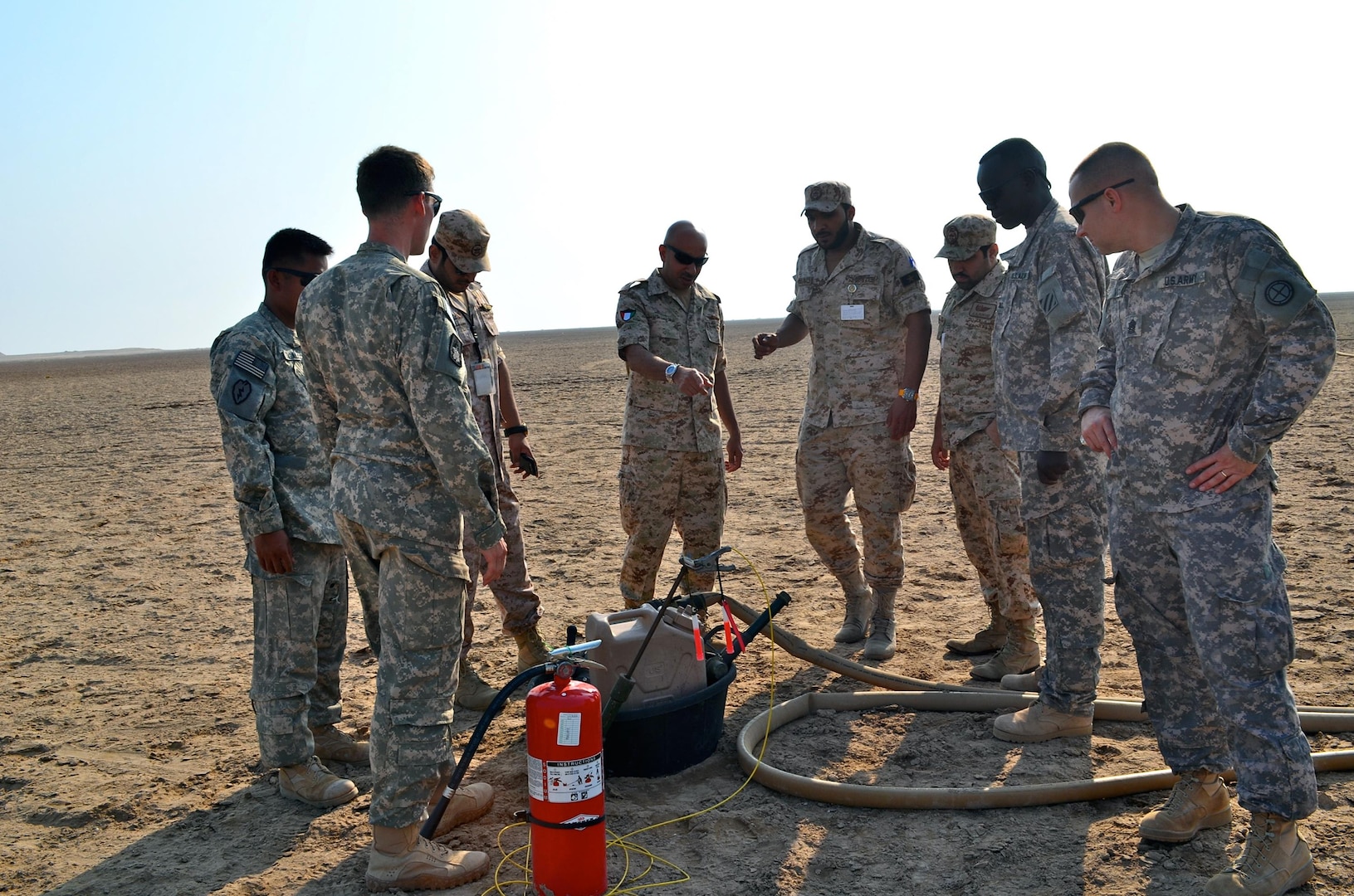 The group gathers around a refueling point to discuss safety and proper fueling techniques.